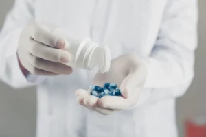 side-view-doctor-with-gloves-holding-pills-bottle-horizontal-2048x1365-1